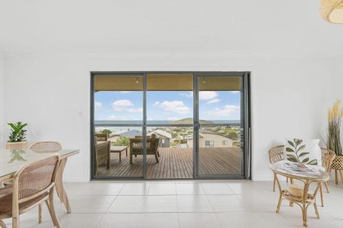 a dining room with a view of the ocean at Seaview at the Bay - Wi-Fi - Oceanview - Near Beach - No Linen Included in Encounter Bay