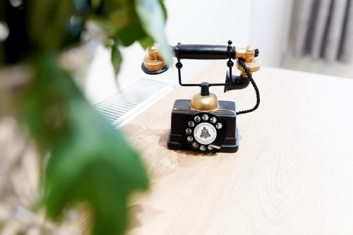 an old fashioned phone sitting on top of a table at Cosy 1 Bed-Flat with Patio Near Heathrow in Stanwell