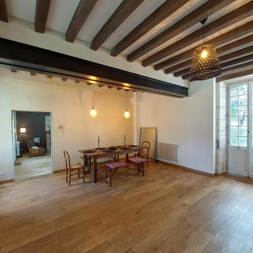 a large room with a wooden table and chairs at La Firmière - Maison de maître - Famille et amis in Omméel