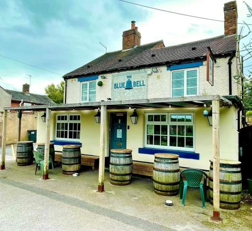 a building with barrels in front of it at Blue Bell Apartment in Kidsgrove