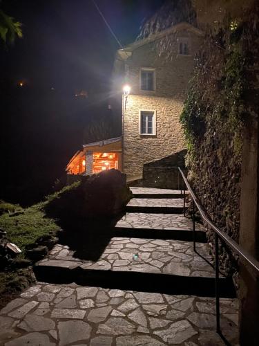 a stone staircase leading to a house at night at L'ALMA VIVA (Anciennement La Diligence) in Verdese