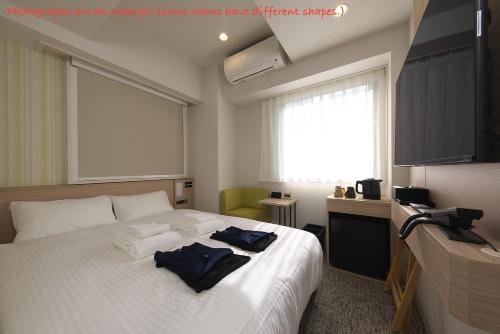 Postel nebo postele na pokoji v ubytování Fourz Hotel Kintetsu Osaka-Namba