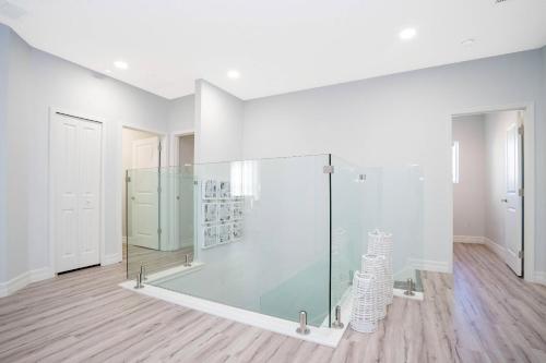 a glass shower in a room with a wooden floor at Top Dluxx Modern Home at Bella Vida Resort 4516 in Kissimmee