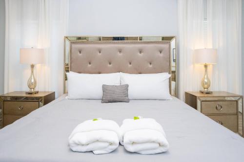 a bedroom with a bed with two towels on it at Top Dluxx Modern Home at Bella Vida Resort 4516 in Kissimmee