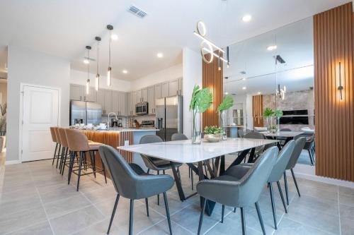 a dining room and kitchen with a table and chairs at Brand New Top Elegance Home at Paradiso 6086 in Orlando