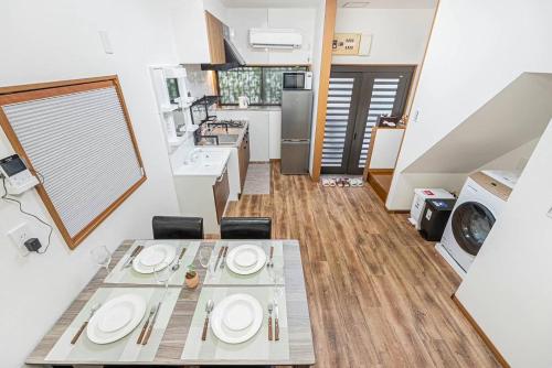 a kitchen with a table and chairs in a room at Tomo house in Tokyo