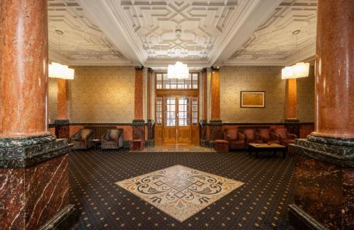 a lobby with a waiting room with chairs and a rug at Cathedral Quarter Hotel - Derby in Derby