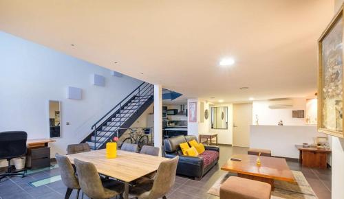 - un salon avec une table à manger et un escalier dans l'établissement Loft triplex 3 chambres doubles, à Villeurbanne