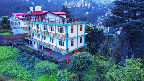 a large house on top of a hill at Shimla Hills Apartments 2BHK in Shimla