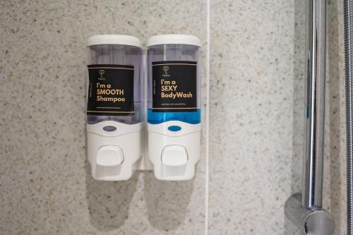 two bottles of hair products in a shower stall at Millerz Square by MyKey in Kuala Lumpur