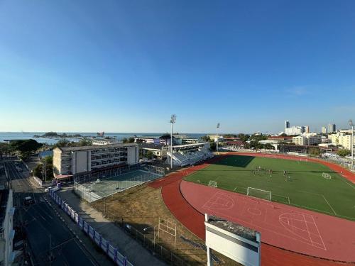 a soccer field in front of a stadium at Sriracha Avenue Serviced Apartment in Si Racha