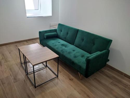 a green couch and a coffee table in a living room at Casa Sáner in Rábade