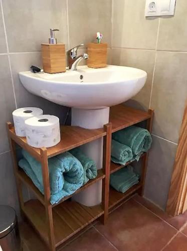 a bathroom with a sink and some towels at La Carpintería nature relax in Tefía