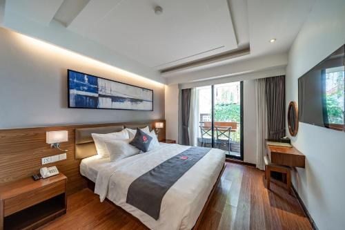 a hotel room with a bed and a large window at Edoya Hotel Ben Thanh in Ho Chi Minh City