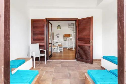 a living room with two beds and a dining room at Villetta Baja Sardinia in Cala Bitta