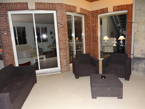 a lobby with couches and chairs and a table at chambres d'hôtes près de FECAMP chez Muriel à Ganzeville le domaine de la roquette in Ganzeville