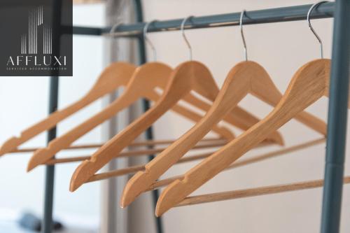 a group of wooden utensils hanging on a rack at Ironbridge Riverside Hot Tub Retreat Sleeps 8 in Ironbridge