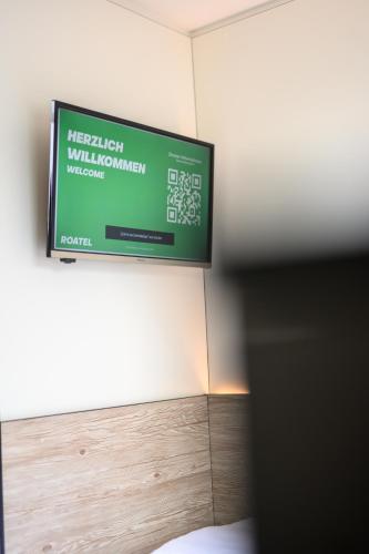 a television on the wall of a room at Roatel Magdeburg A2 my-roatel-com in Magdeburg
