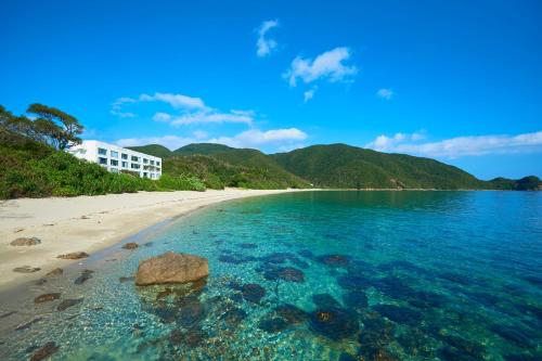 a view of a beach with a building in the background at Hotel The Scene in Setouchi