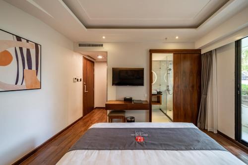 a hotel room with a bed and a television at Edoya Hotel Ben Thanh in Ho Chi Minh City