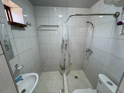 un bagno con doccia, WC e lavandino di Shaxboz Guest House a Samarkand