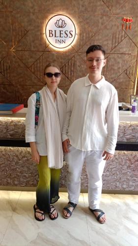 a man and a woman standing in front of a restaurant at BLESS INN - Near Connaught Place in New Delhi