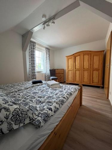 a bedroom with a bed with a black and white comforter at Ferienwohnung Lange in Kalbe