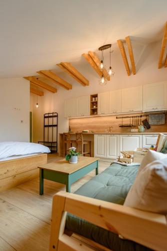 a living room with a bed and a table at Dom pri jazere, Bešeňová in Bešeňová