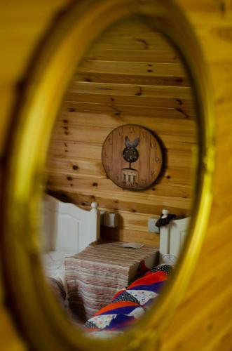 a room with a clock in a wooden wall at Tammispea puhkeküla in Tammispea