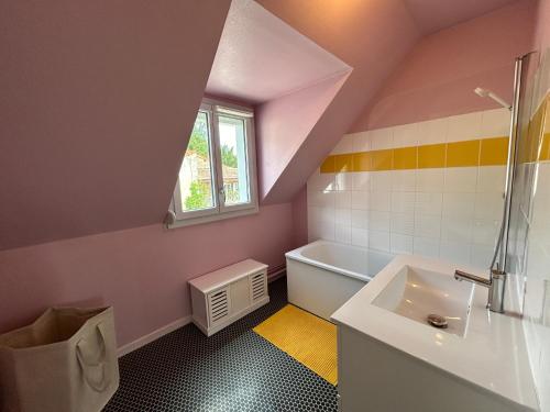 un bagno con una vasca bianca e un lavandino di Maison avec jardin a Buxy