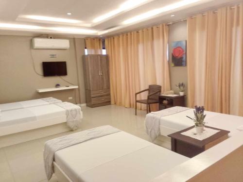 a hospital room with two beds and a table at Cliff Haven Resort in Jagna