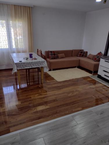 a living room with a couch and a table at Kostadinovic in Pršini