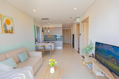 a living room with a couch and a dining room at The Song Luxury Vung Tau Apartment - QUỲNH's Homestay in Vung Tau