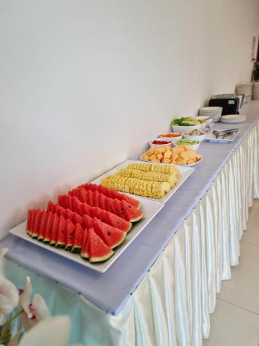 a buffet line with many different types of food at The Sand Beach Pattaya in Na Jomtien
