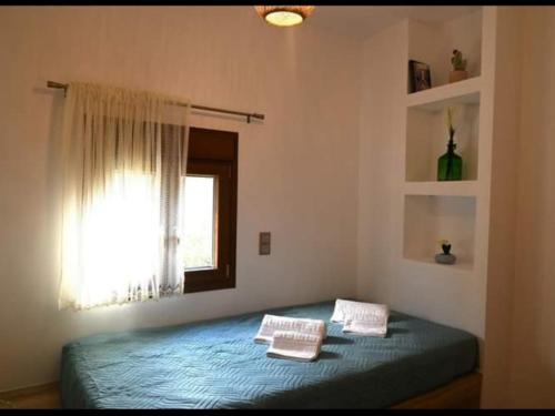 a bedroom with a bed with two pillows on it at Anezina Cretan hospitality in Heraklion