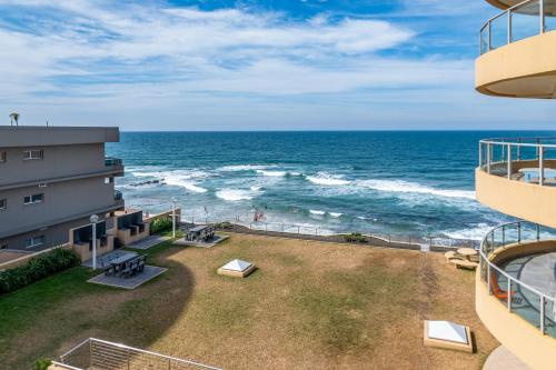a view of the ocean from the balcony of a building at Bermuda 302 in Ballito