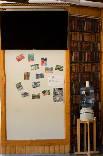 a bulletin board in a library with pictures on it at Tammispea puhkeküla in Tammispea