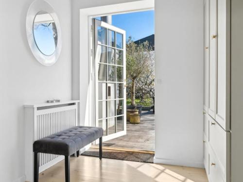 a room with a bench and an open door at Sanders Swan - Marvellous villa close to the center of Copenhagen in Copenhagen
