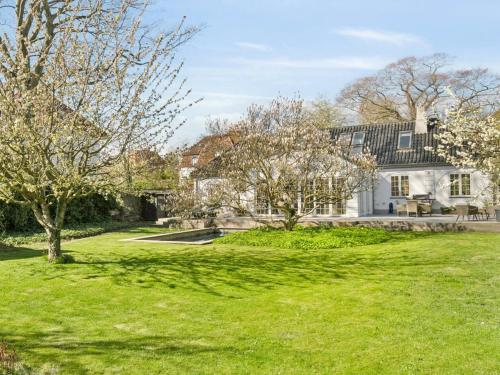 a house with a green lawn in front of it at Sanders Swan - Marvellous villa close to the center of Copenhagen in Copenhagen