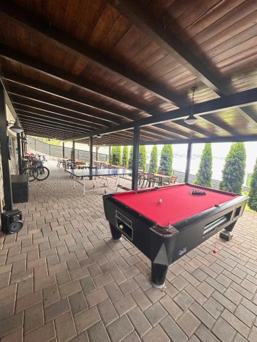 a pool table sitting on a patio with a roof at Casa Dani in Colibiţa