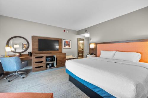 a hotel room with a large bed and a television at Hampton Inn & Suites - Saint Louis South Interstate 55 in Saint Louis