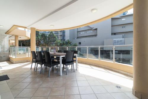 a patio with a table and chairs on a balcony at Bermuda 302 in Ballito