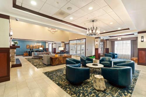 a lobby with blue chairs and a living room at Doubletree By Hilton Front Royal Blue Ridge Shadows in Front Royal