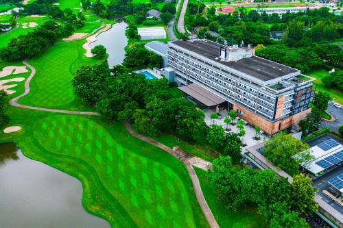 an aerial view of a building on a golf course at Tinidee Hotel Bangkok Golf Club in Pathum Thani