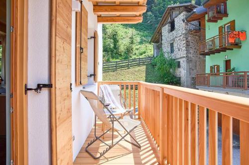 a rocking chair on the balcony of a house at Ai Masetti di TSS'- Riposo nel Verde, curato, silenzioso in Vignola