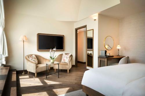 a hotel room with a bed and a tv at Brunfels Hotel, in the Unbound Collection by Hyatt in Mainz