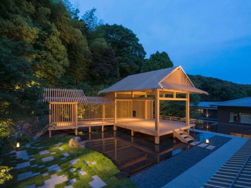 a large wooden gazebo next to a pool at Banyan Tree Higashiyama Kyoto in Kyoto