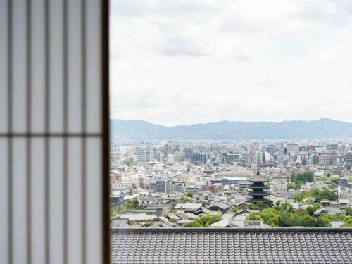 a view of a city from a window at Banyan Tree Higashiyama Kyoto in Kyoto