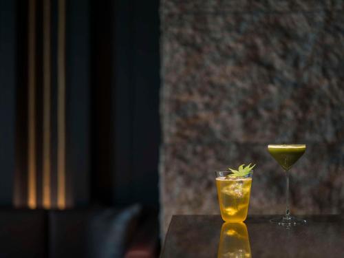 a drink and a martini glass sitting on a table at Banyan Tree Higashiyama Kyoto in Kyoto