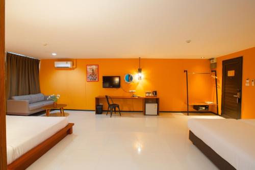 a hotel room with two beds and a living room at MeStyle Place Hotel in Bangkok